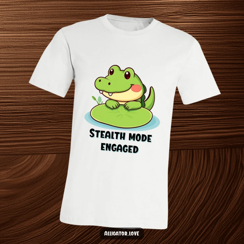 Funny cute alligator peeking from behind a lily pad, a humorous t-shirt for playful people.